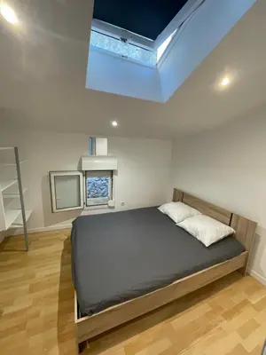 a bedroom with a bed and a tv in it at Appartement dans le village à port la nouvelle in Port-la-Nouvelle