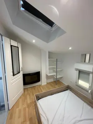 a room with a white ceiling with a skylight at Appartement dans le village à port la nouvelle in Port-la-Nouvelle