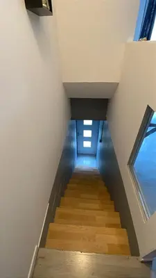a staircase in a house with a window at Appartement dans le village à port la nouvelle in Port-la-Nouvelle