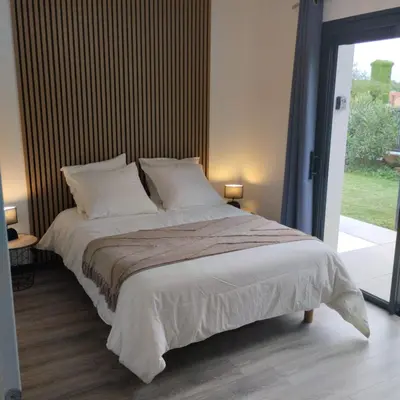 a bed with white sheets and pillows in a bedroom at Le Logis de la Voie Verte in Saint-Amadou
