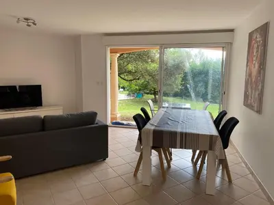 a living room with a dining room table and a couch at Dépendance paisible in Ventenac-Cabardès
