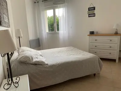 a bedroom with a bed and a dresser and a window at Dépendance paisible in Ventenac-Cabardès