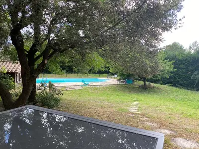 a swimming pool with a ramp next to a tree at Dépendance paisible in Ventenac-Cabardès