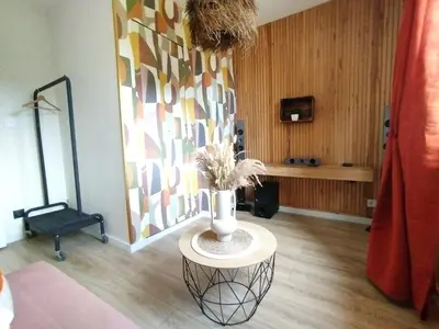 a room with a vase with flowers on a table at La maison des moments in Carcassonne