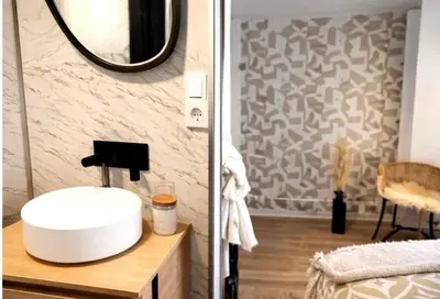 a bathroom with a white sink and a mirror at La maison des moments in Carcassonne