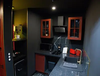 a small kitchen with a sink and a microwave at Studio Cinéma privé Centre ville & King size in Narbonne
