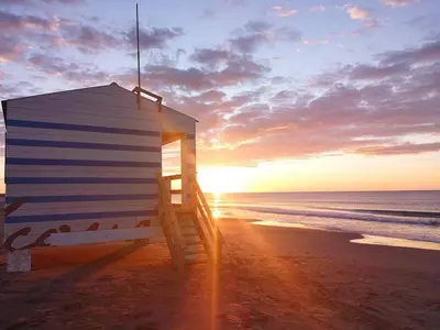 a lifeguard shack on the beach at sunset at Maison dans le sud au calme avec extérieur in Ferrals-lès-Corbières