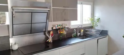 a kitchen with a sink and a black counter top at Maison dans le sud au calme avec extérieur in Ferrals-lès-Corbières