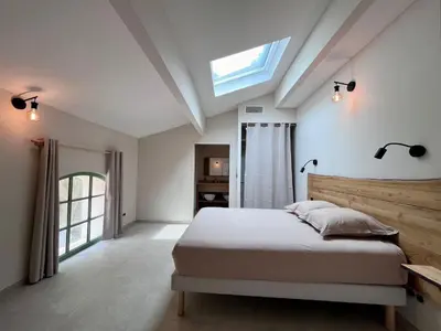 a bedroom with a bed and a skylight at Villa Les Charmes in Narbonne