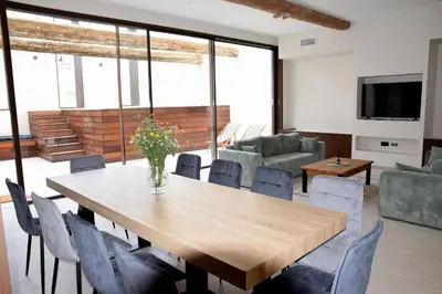 a dining room with a table and chairs at Villa Les Charmes in Narbonne