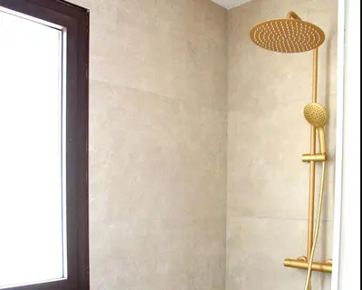 a shower with a shower head in a bathroom at Villa Les Charmes in Narbonne