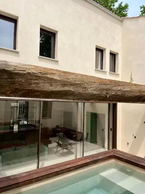 a house with a swimming pool with a log on top of it at Villa Les Charmes in Narbonne