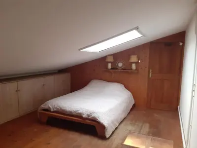 a bedroom with a bed and a light on the ceiling at Gîte à la ferme in Montolieu