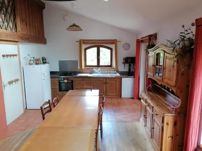a kitchen with a long wooden table in a room at Gîte à la ferme in Montolieu