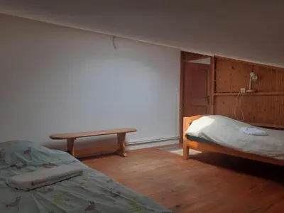 a bedroom with a bed and a table in it at Gîte à la ferme in Montolieu