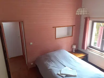 a bedroom with a bed and a window at Gîte à la ferme in Montolieu