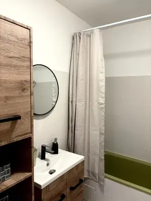a bathroom with a sink and a shower curtain at Appartement T2 in Port-la-Nouvelle