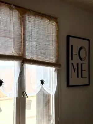 a window with white curtains in a room at Appartement T2 in Port-la-Nouvelle