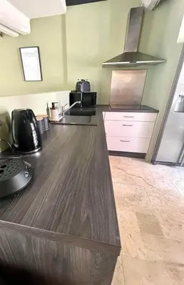 a kitchen with a wooden counter top in a room at La Loge des Remparts in Carcassonne
