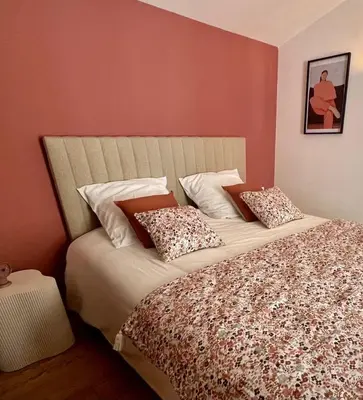 a bed with two pillows on it in a bedroom at La Loge des Remparts in Carcassonne