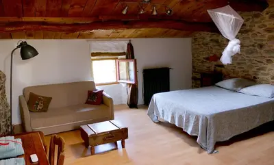 a bedroom with a bed and a couch at La Terrasse aux citronniers in Saint-Vincent
