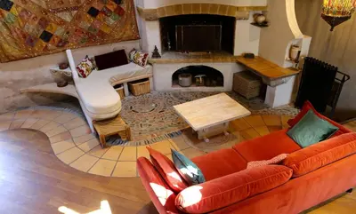 a living room with a couch and a fireplace at La Terrasse aux citronniers in Saint-Vincent