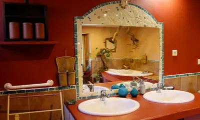 a bathroom with two sinks and a large mirror at La Terrasse aux citronniers in Saint-Vincent