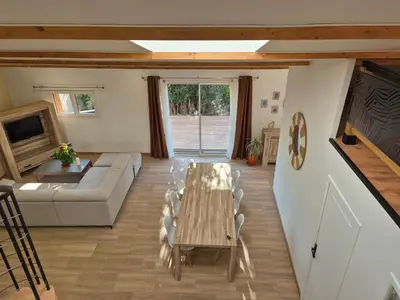 a living room with a table and a couch at Le Gîte du Parc in Roubia