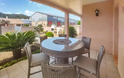 a patio with a table and chairs on a balcony at Nice Home In Cessenon Sur Orb - Flh677 in Cessenon