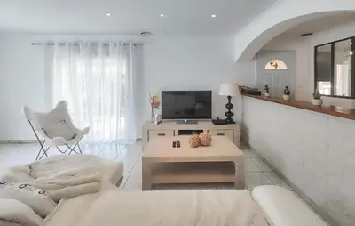a white living room with a couch and a tv at Nice Home In Cessenon Sur Orb - Flh677 in Cessenon