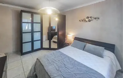 a bedroom with a large bed and a large mirror at Nice Home In Cessenon Sur Orb - Flh677 in Cessenon