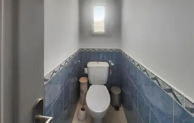 a bathroom with a toilet with blue tiles at Nice Home In Cessenon Sur Orb - Flh677 in Cessenon