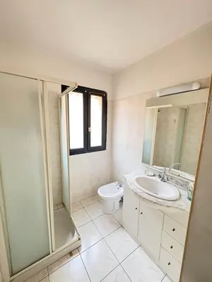 a bathroom with a sink and a shower and a toilet at Spacieux appartement Coeur du Village Wifi Draps in Gruissan