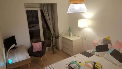 a bedroom with a bed and a desk and a chair at Apartment with large terrace, ground floor in Narbonne