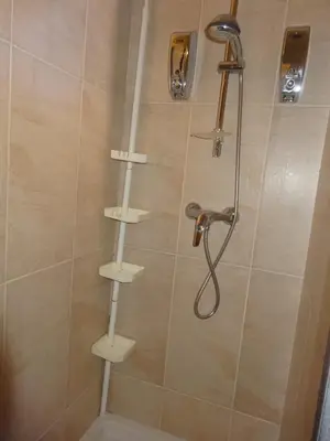 a shower with white shelves in a bathroom at Apartment with large terrace, ground floor in Narbonne