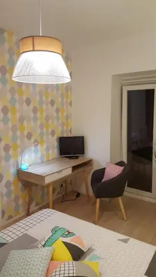 a room with a desk with a laptop and a chair at Apartment with large terrace, ground floor in Narbonne
