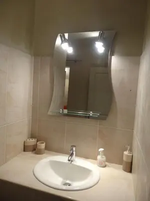 a bathroom with a sink and a mirror at Apartment with large terrace, ground floor in Narbonne