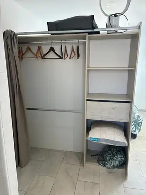 a walk in closet with shelves and hangers at villa de vacances in Cessenon