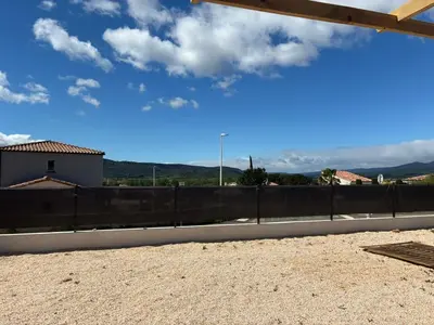 a view from the roof of a house with a fence at villa de vacances in Cessenon