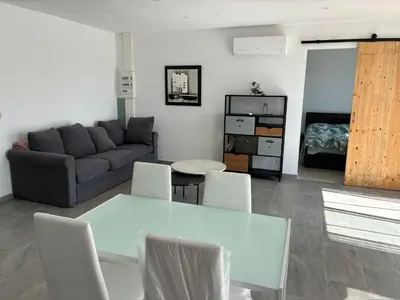 a living room with a couch and a table and chairs at villa de vacances in Cessenon