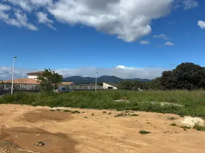 a field with a dirt road and a blue sky at villa de vacances in Cessenon