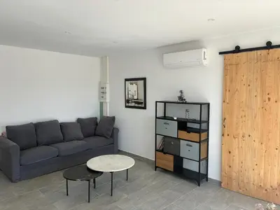 a living room with a couch and a table at villa de vacances in Cessenon