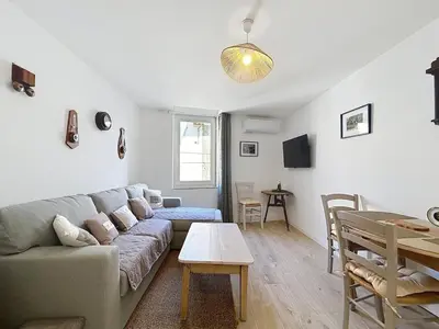 a living room with a couch and a table at Le Lies - Appartement proche de la mer in Salles-d'Aude