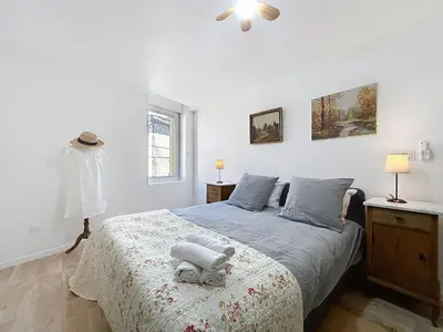 a bedroom with a bed with a stuffed animal on it at Le Lies - Appartement proche de la mer in Salles-d'Aude
