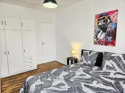 a bedroom with a bed and a painting on the wall at Maison de vacances en Ariège in La Bastide-de-Bousignac