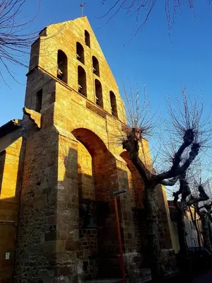 a tall brick building with a tower with windows at Maison de vacances en Ariège in La Bastide-de-Bousignac