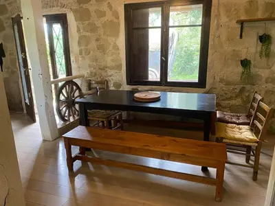 a dining room with a table and a bench at Beautiful large country house 4 bedrooms in Teyssode
