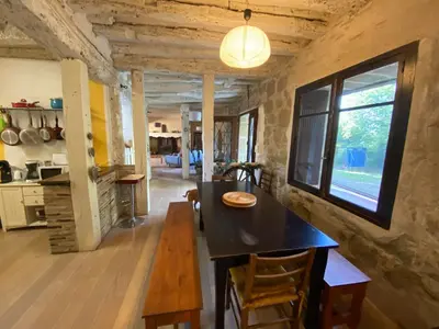 a kitchen and dining room with a table and a window at Beautiful large country house 4 bedrooms in Teyssode