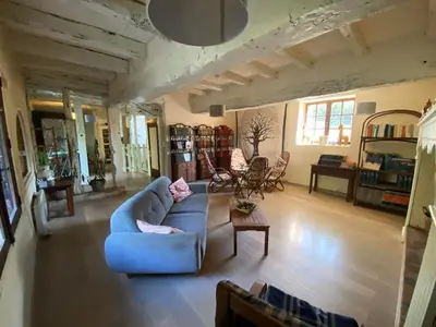 a living room with a blue couch and a table at Beautiful large country house 4 bedrooms in Teyssode