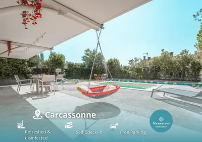 a red boat on a patio next to a swimming pool at Ambiance sudiste , piscine, boule, farniente AG in Carcassonne